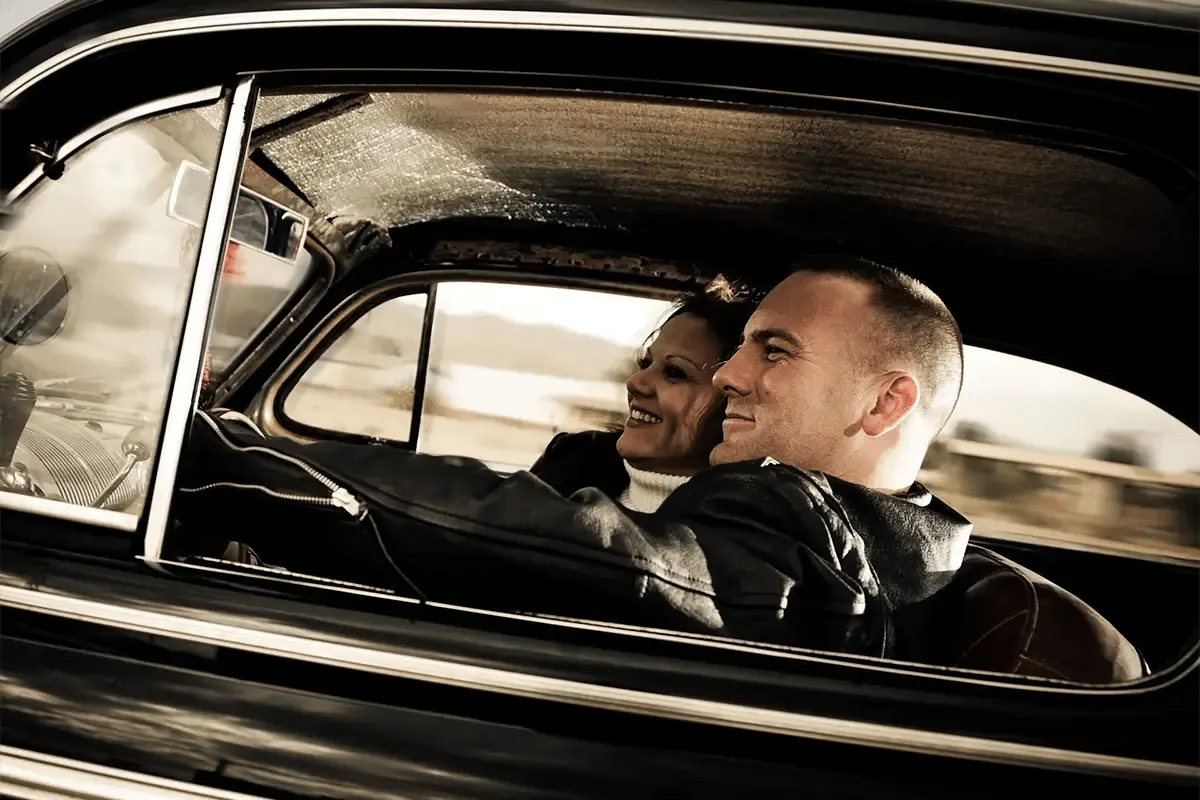 Happy couple enjoying driving their car following panel beating repairs
